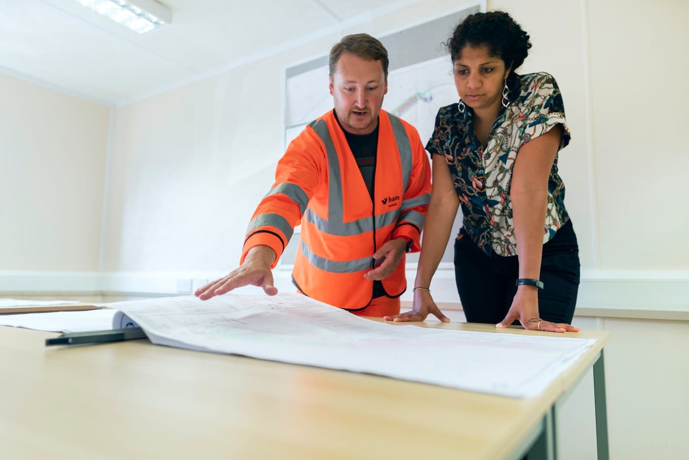 Engineers reviewing technical drawings at a site office